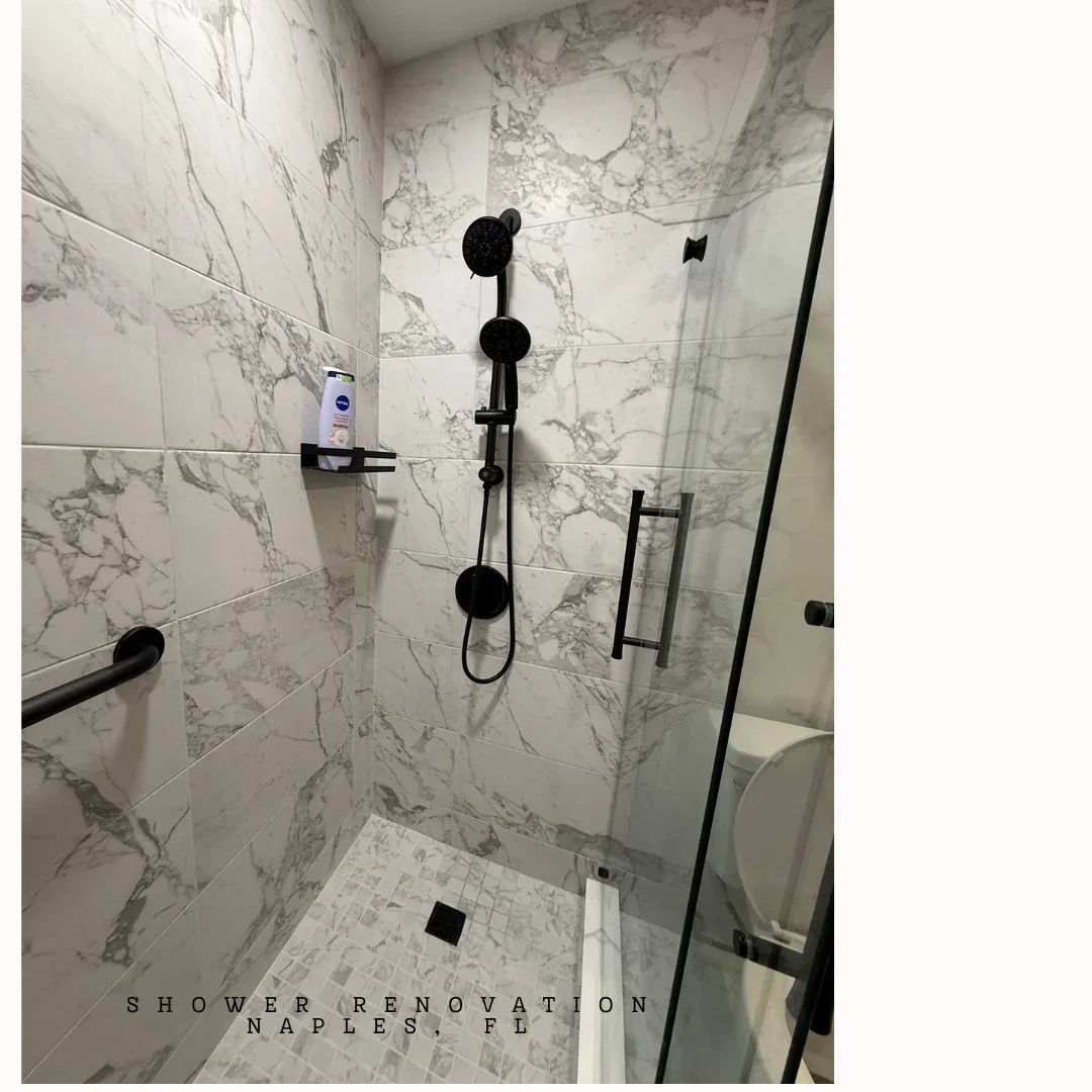 Marble tile shower with black fixtures, rainfall showerhead, and mosaic floor